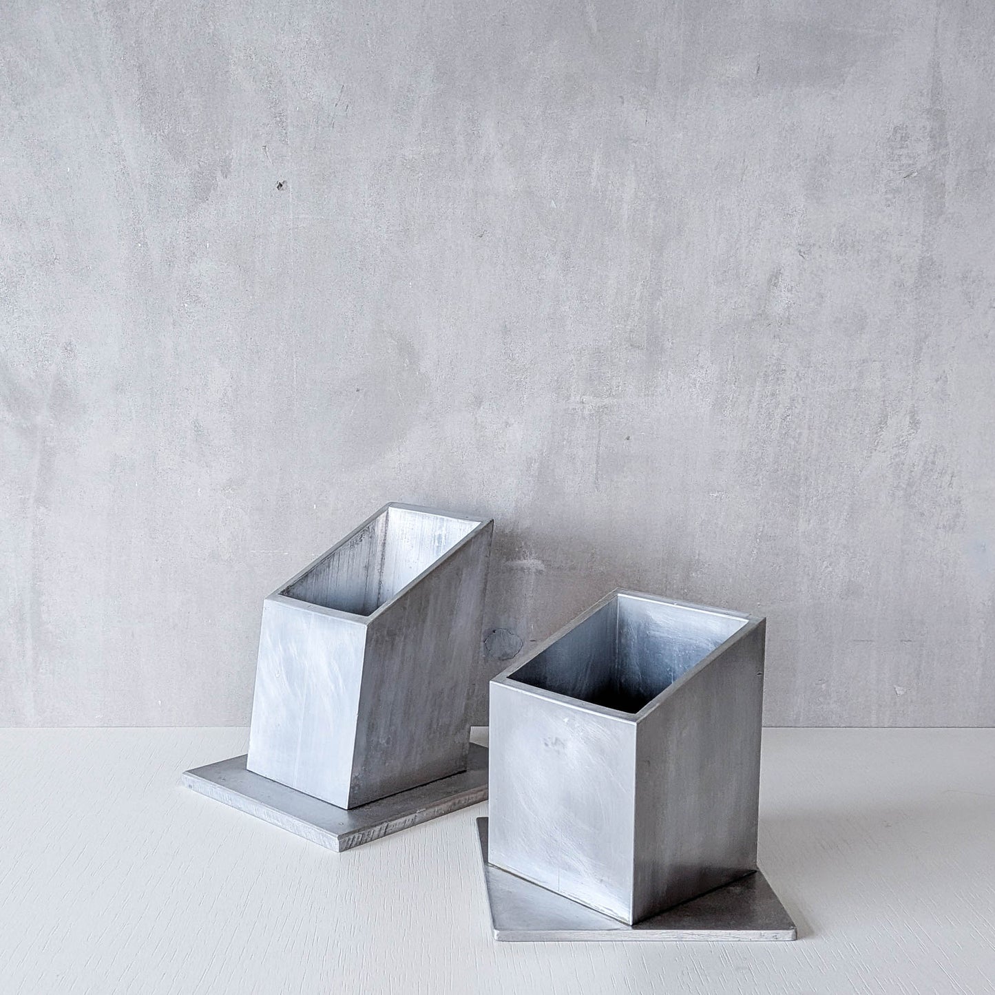 Pair of vintage scratch built sculptural aluminium desk tidy pen holders