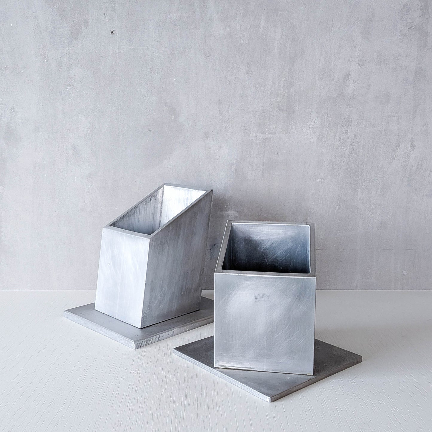 Pair of vintage scratch built sculptural aluminium desk tidy pen holders