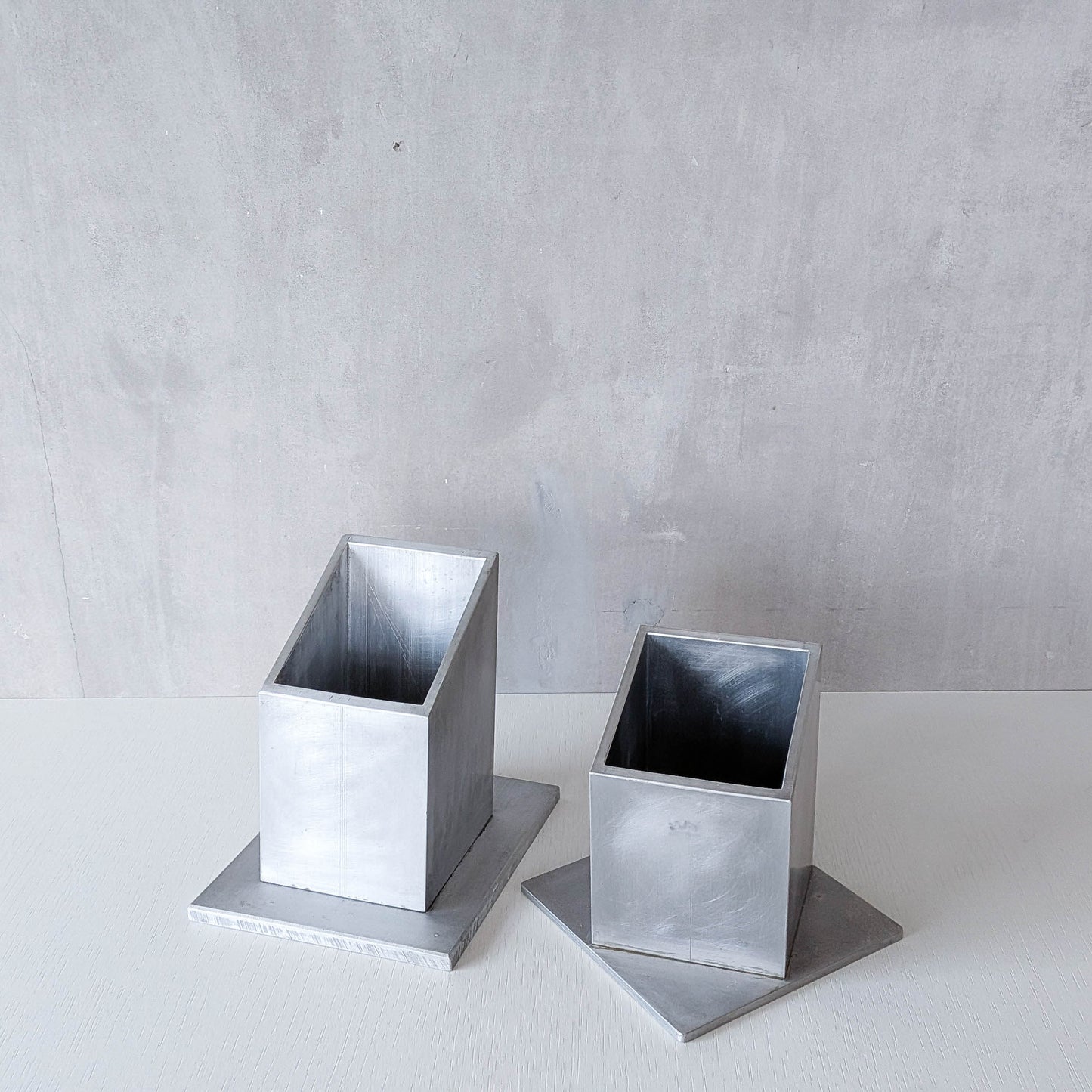 Pair of vintage scratch built sculptural aluminium desk tidy pen holders