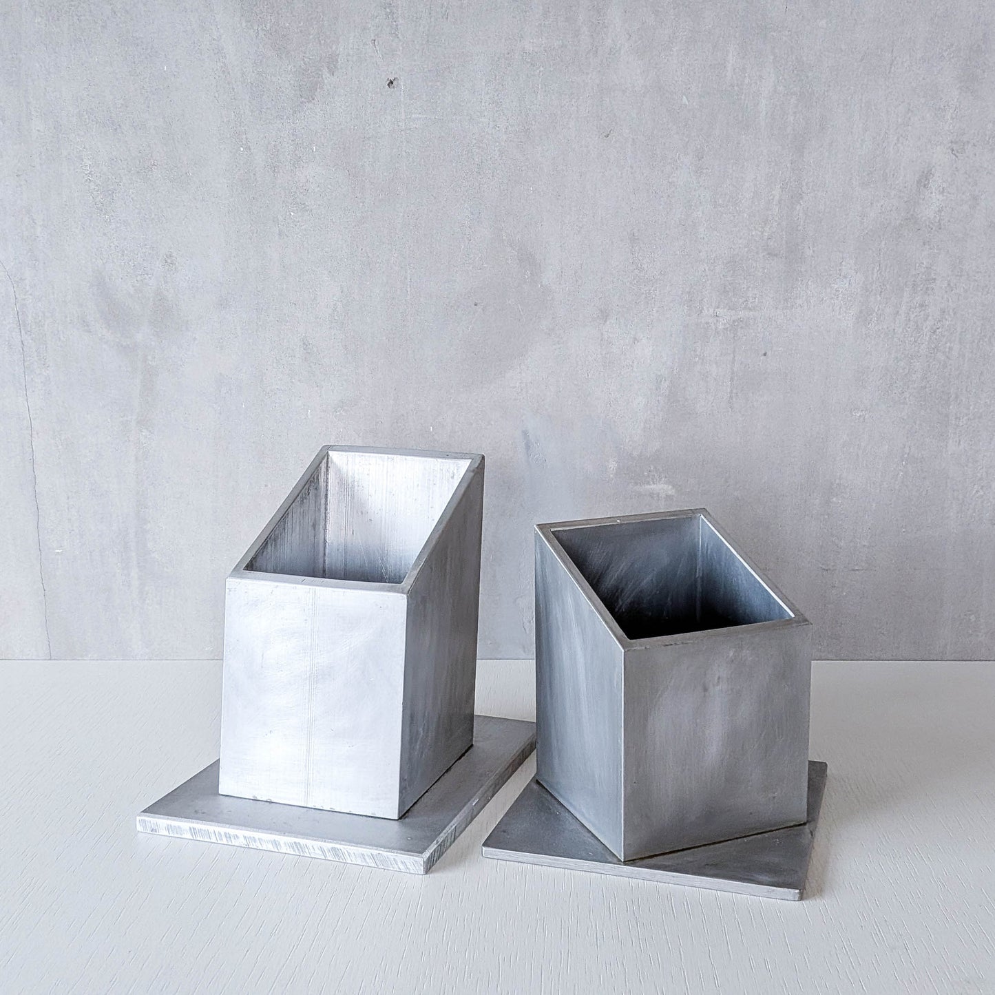 Pair of vintage scratch built sculptural aluminium desk tidy pen holders