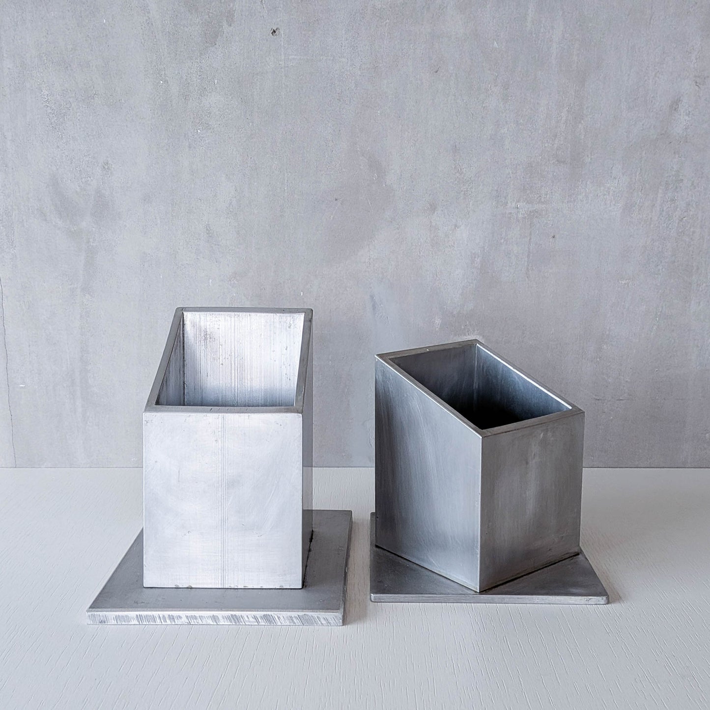Pair of vintage scratch built sculptural aluminium desk tidy pen holders