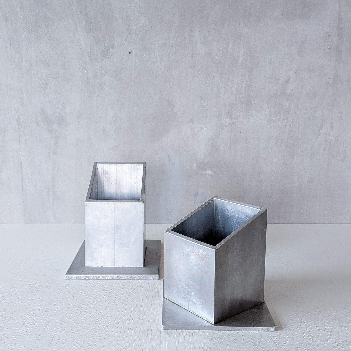 Pair of vintage scratch built sculptural aluminium desk tidy pen holders