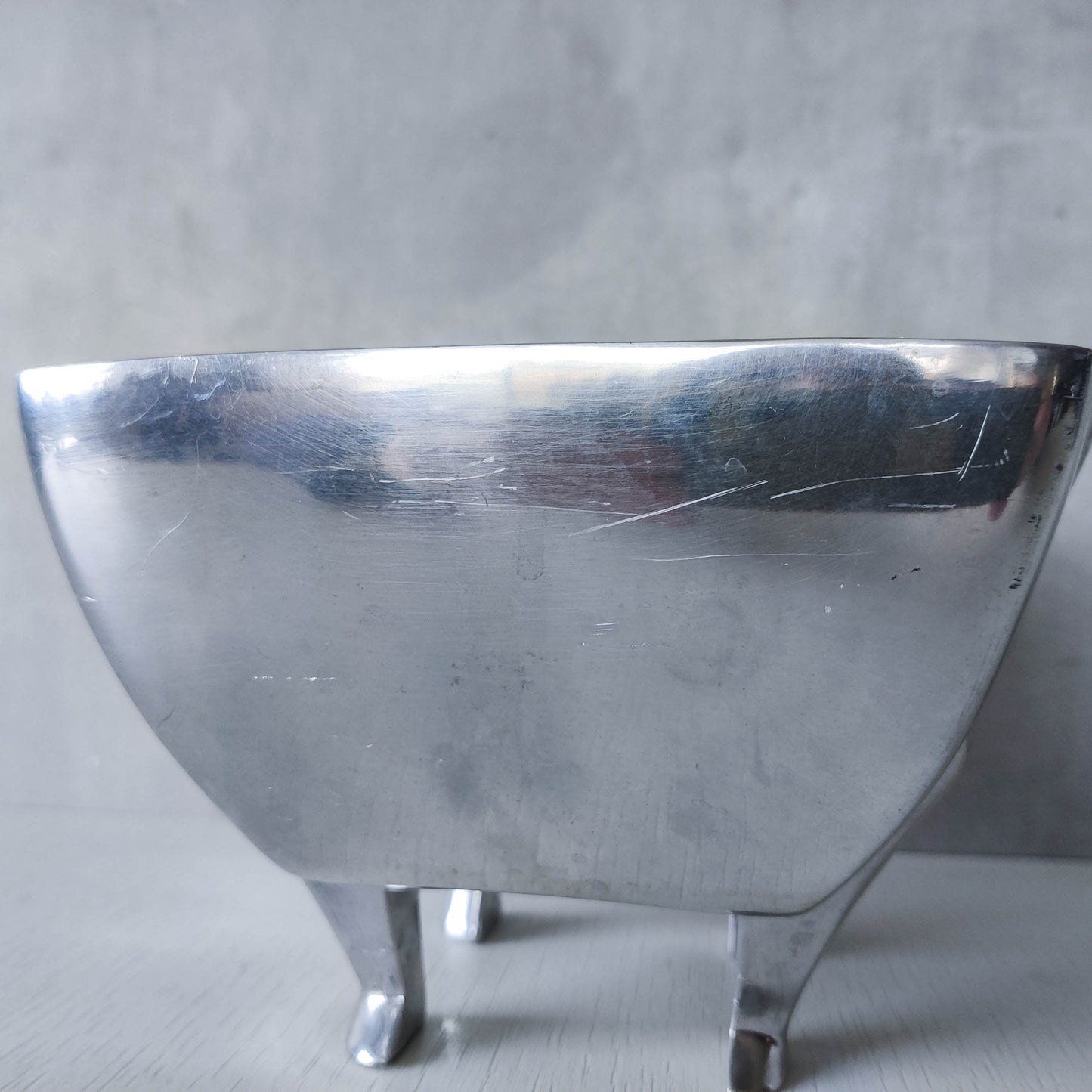 Carrol Boyes 1990s sculptural cast aluminium rectangular fruit bowl with figural feet