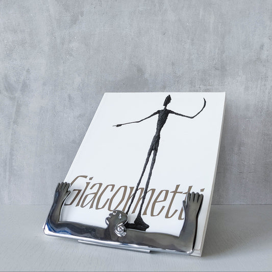 A Carrol Boyes sculpural figural cast metal book stand easel