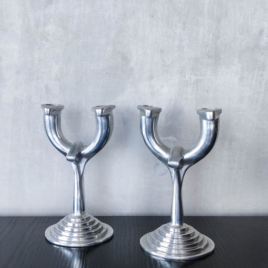 Vintage cast aluminium modernist sculptural pair of candelabras with stepped bases