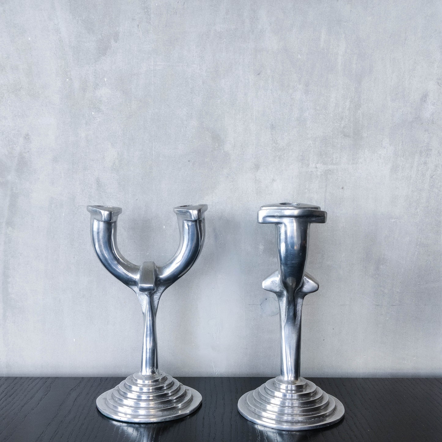 Vintage cast aluminium modernist sculptural pair of candelabras with stepped bases