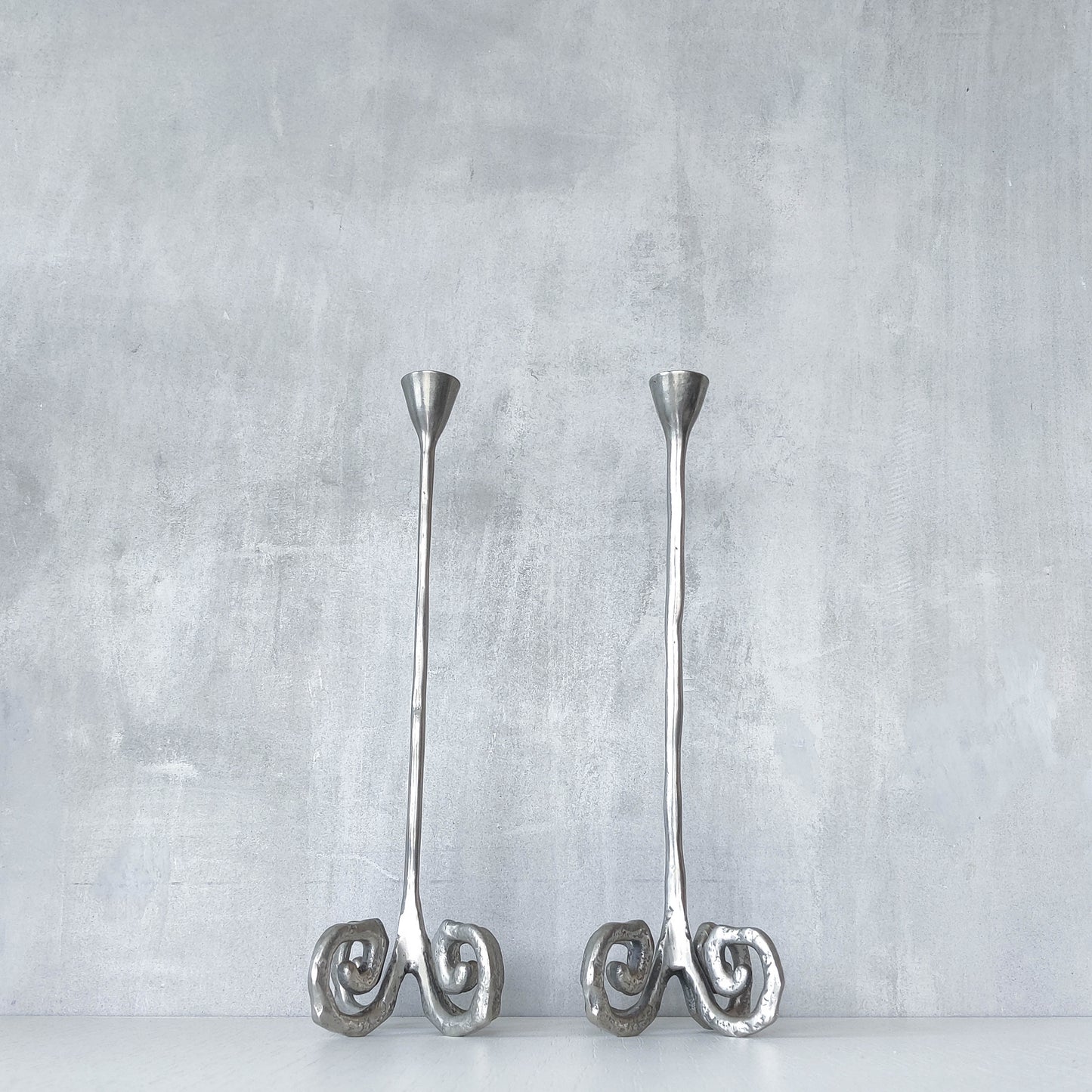 Pair of vintage cast aluminium candle holders with spiral feet
