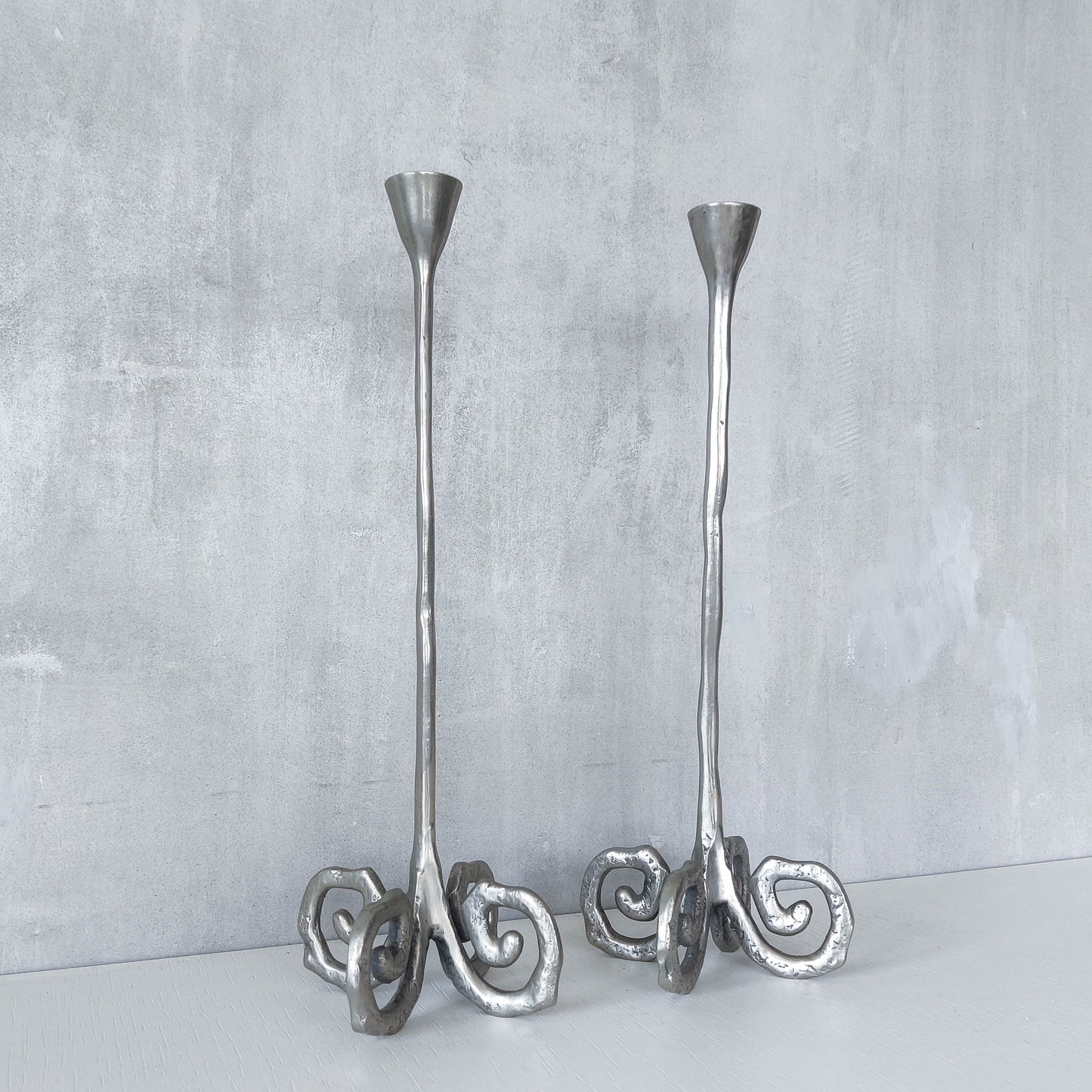 Pair of vintage cast aluminium candle holders with spiral feet