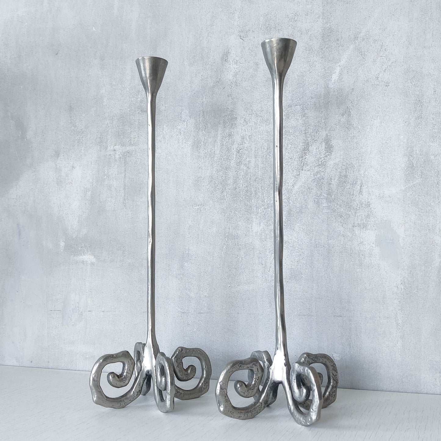 Pair of vintage cast aluminium candle holders with spiral feet