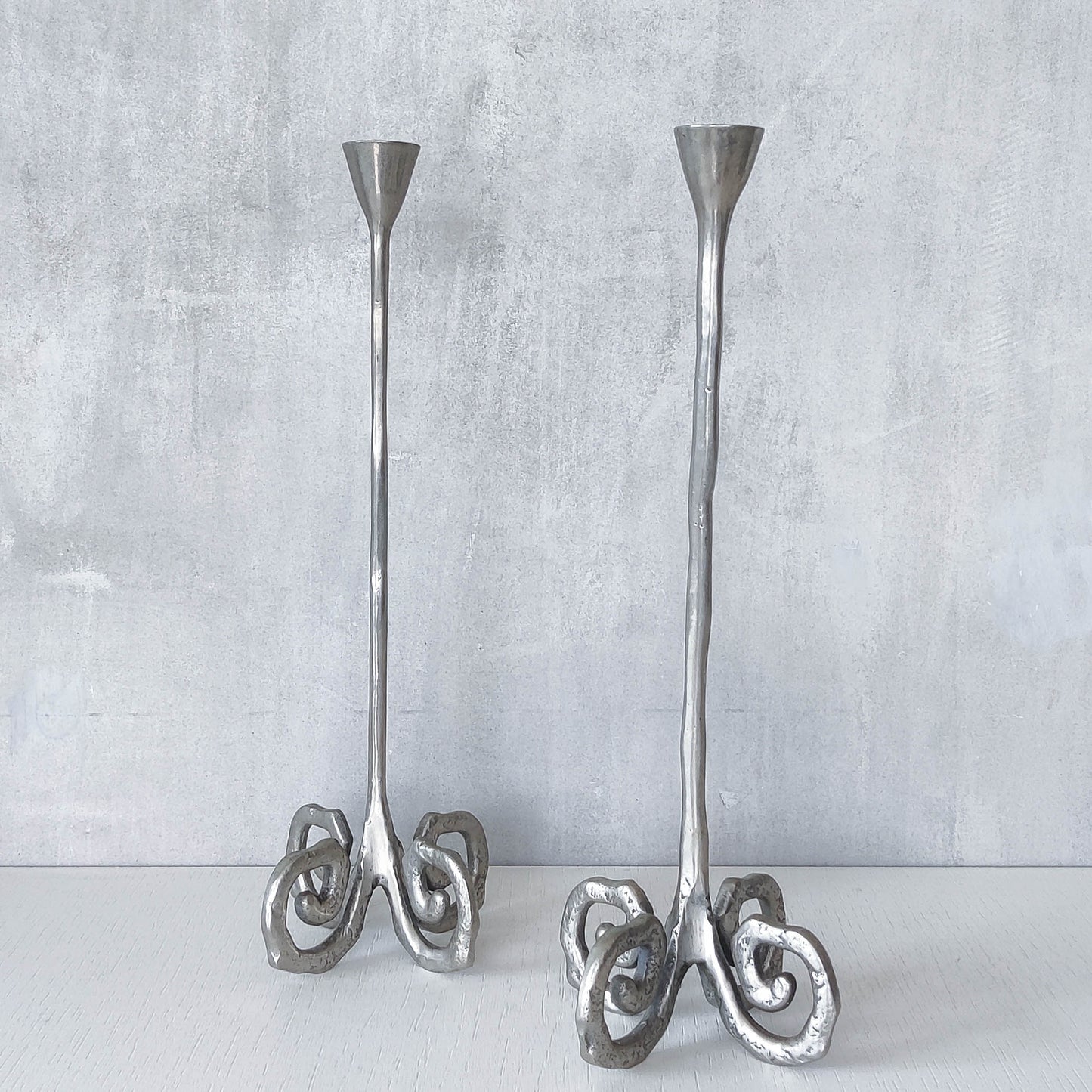 Pair of vintage cast aluminium candle holders with spiral feet