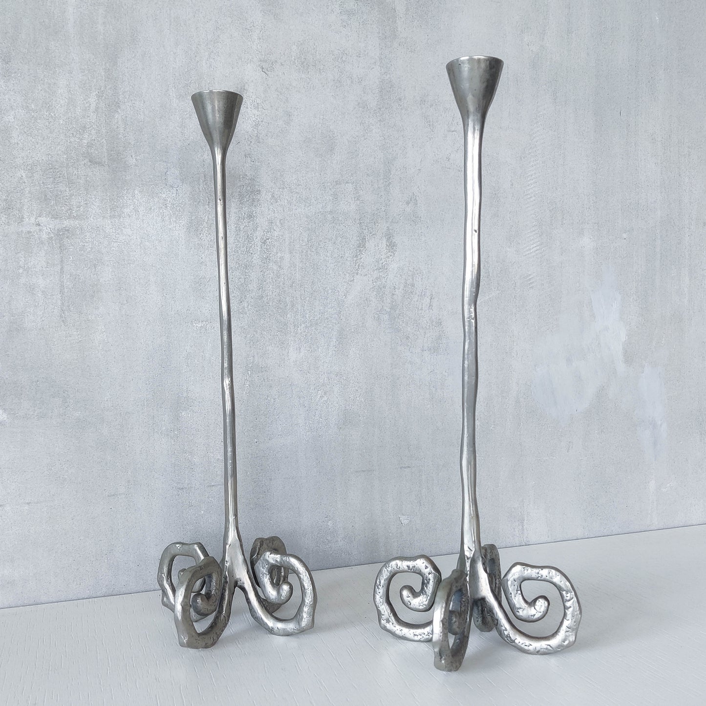 Pair of vintage cast aluminium candle holders with spiral feet