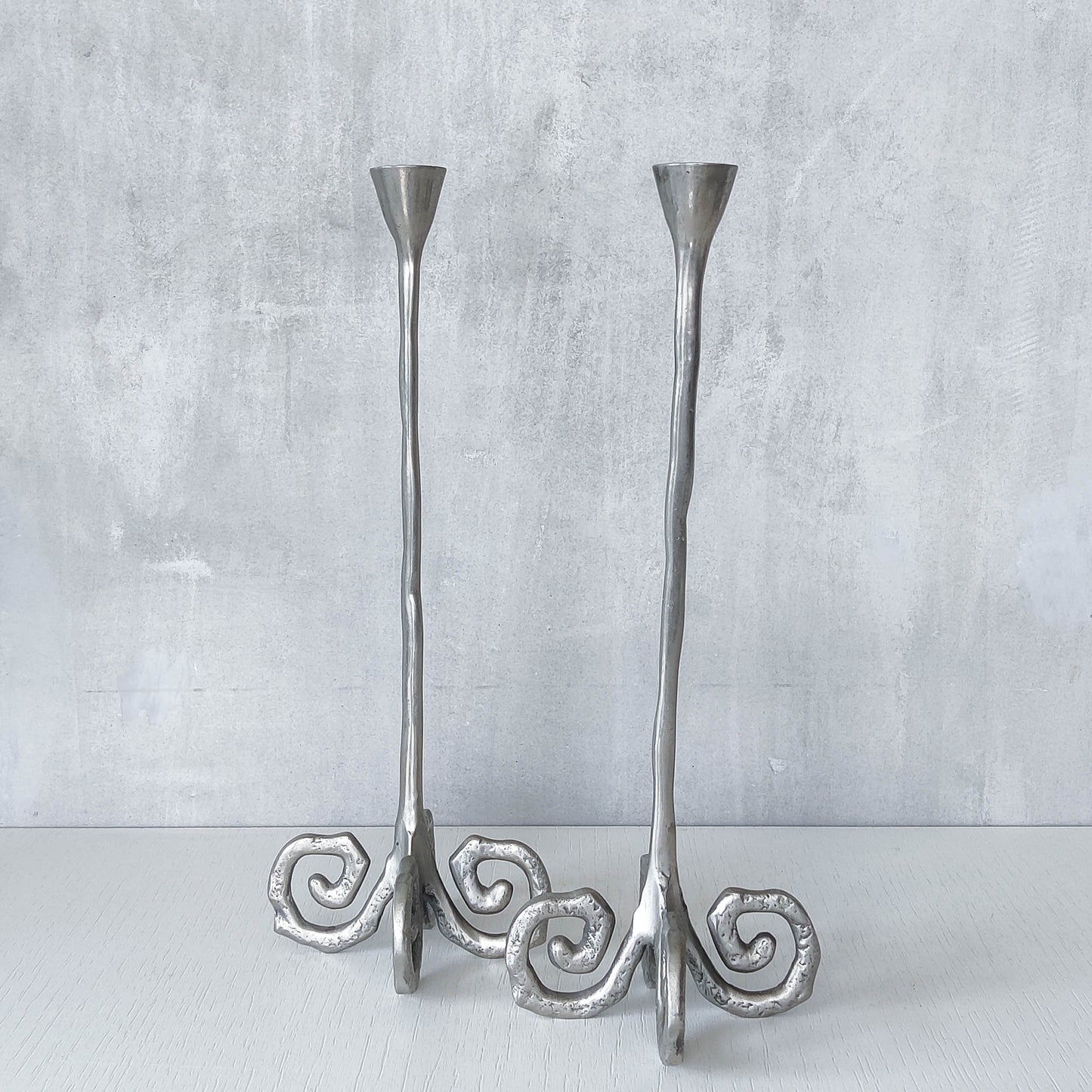 Pair of vintage cast aluminium candle holders with spiral feet