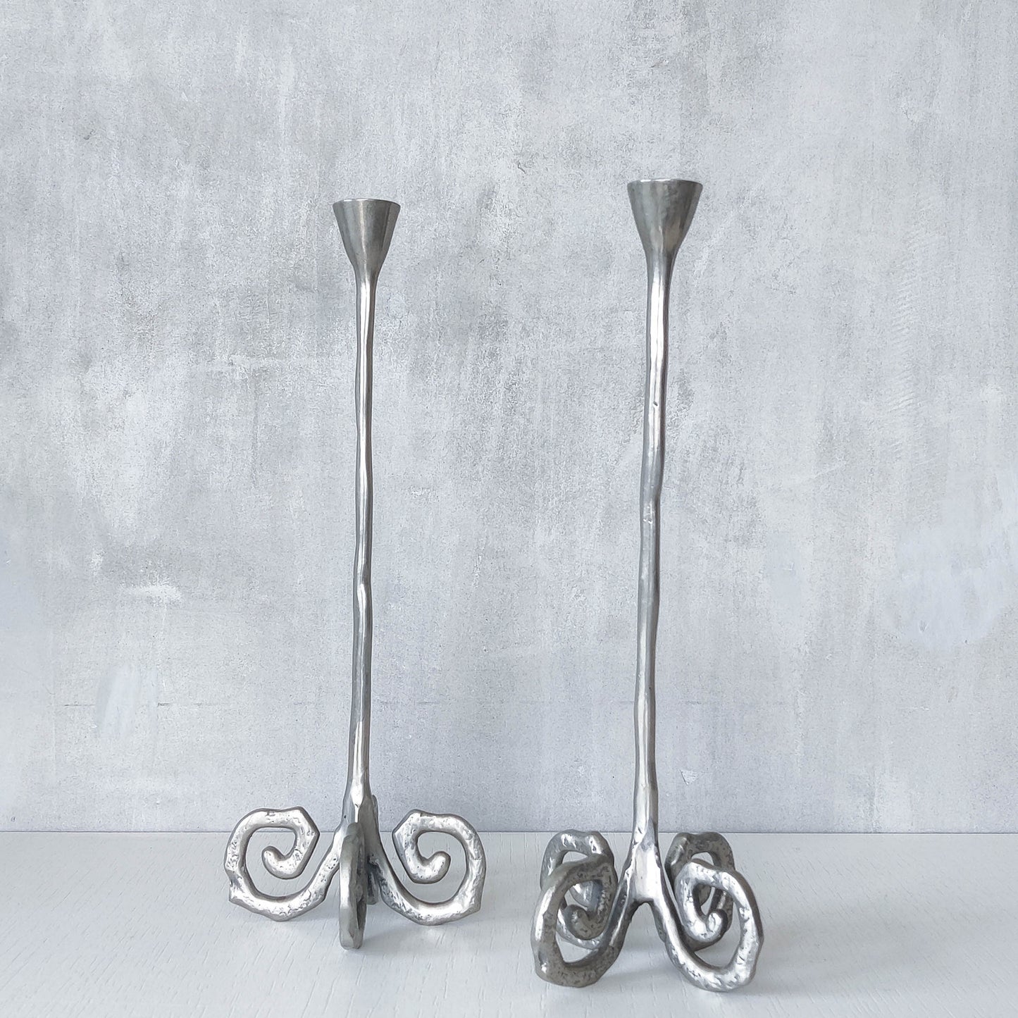 Pair of vintage cast aluminium candle holders with spiral feet