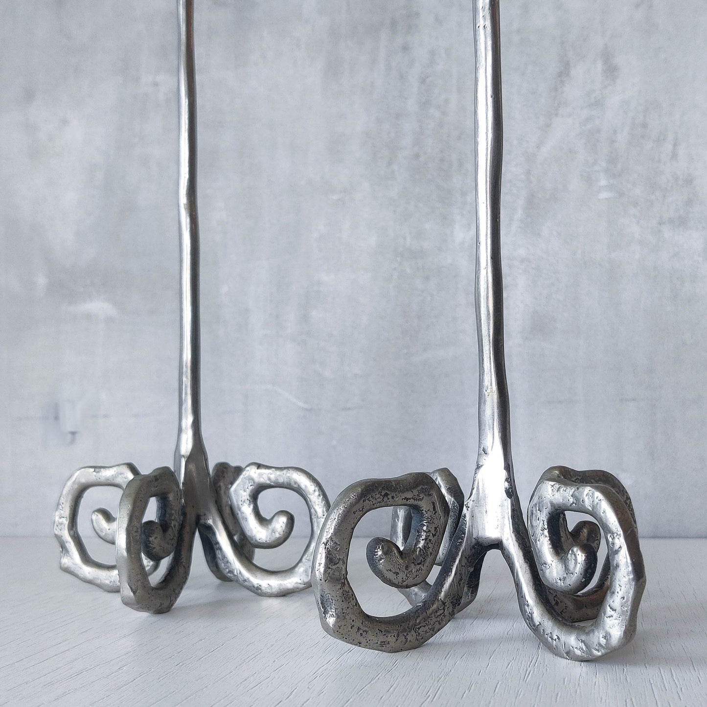 Pair of vintage cast aluminium candle holders with spiral feet