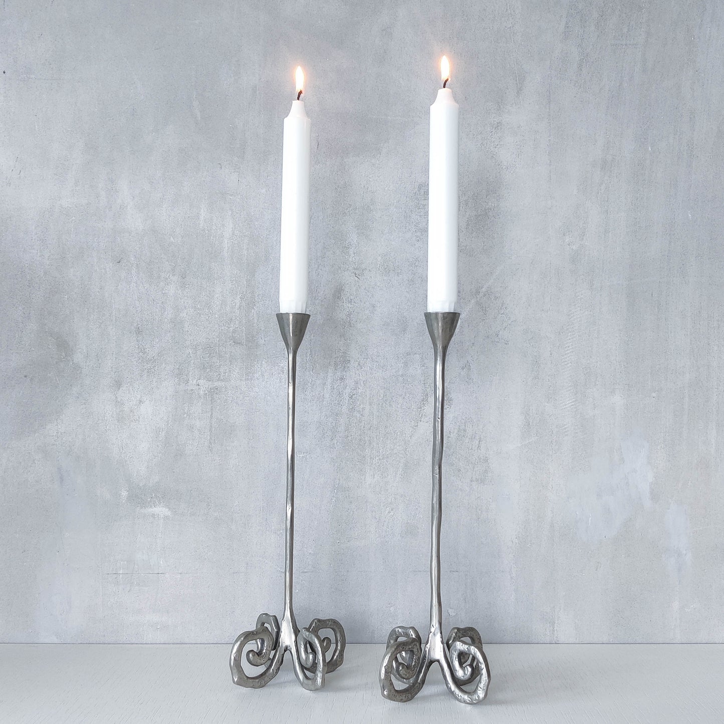Pair of vintage cast aluminium candle holders with spiral feet