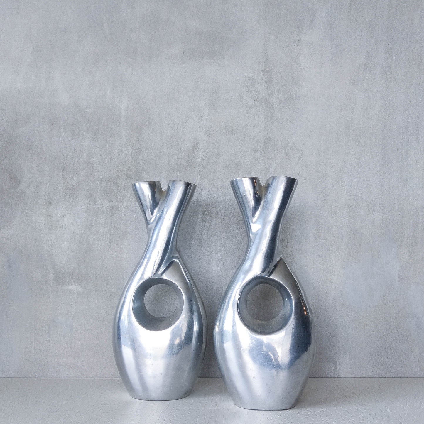Pair of vintage cast aluminium sculptural donut twist vases