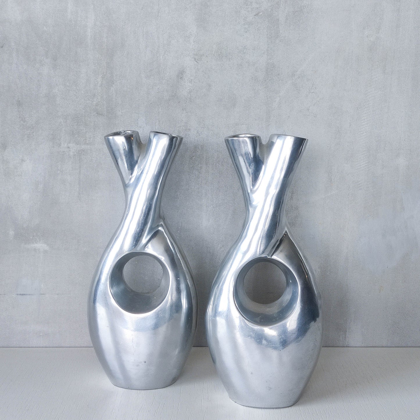 Pair of vintage cast aluminium sculptural donut twist vases