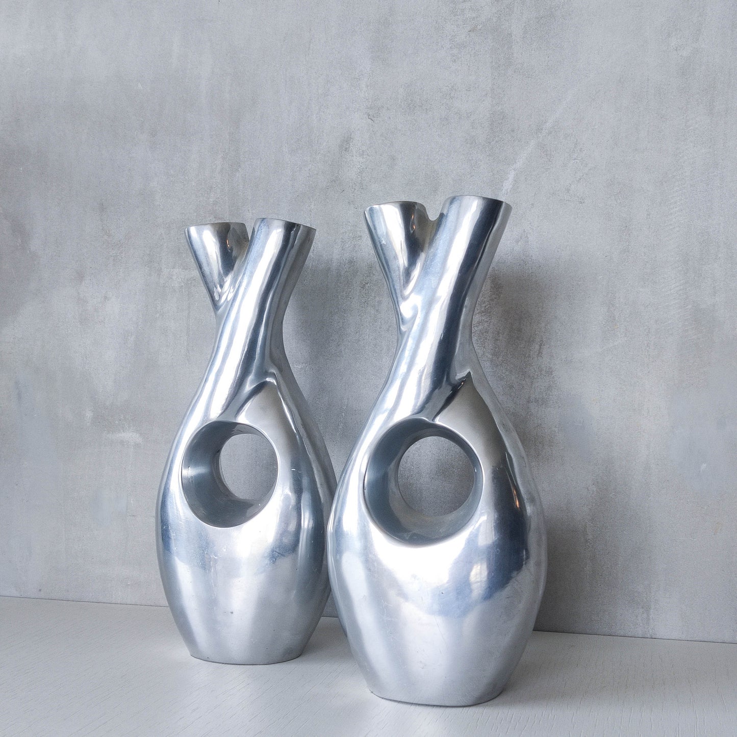 Pair of vintage cast aluminium sculptural donut twist vases