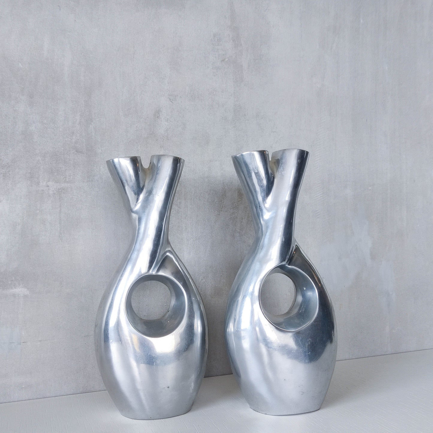 Pair of vintage cast aluminium sculptural donut twist vases
