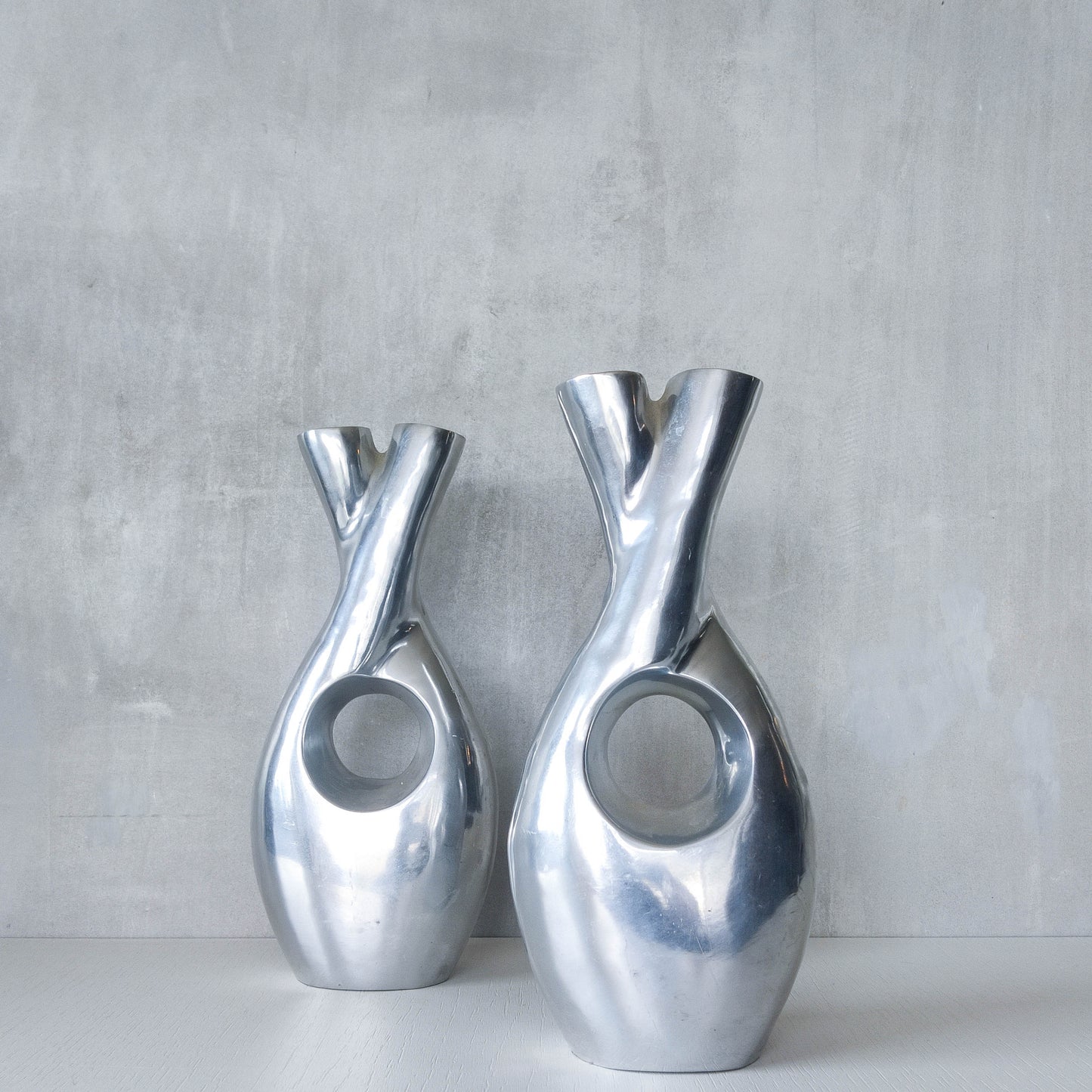Pair of vintage cast aluminium sculptural donut twist vases