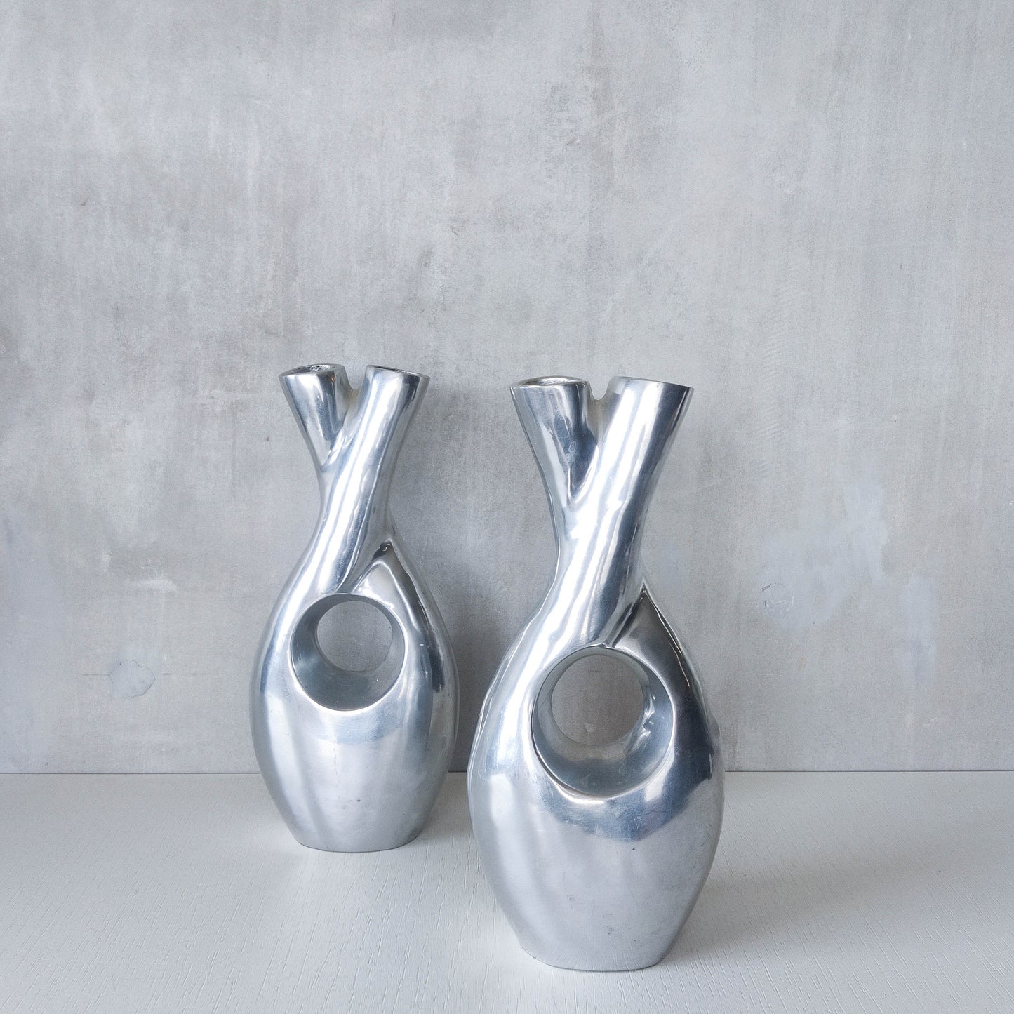 Pair of vintage cast aluminium sculptural donut twist vases