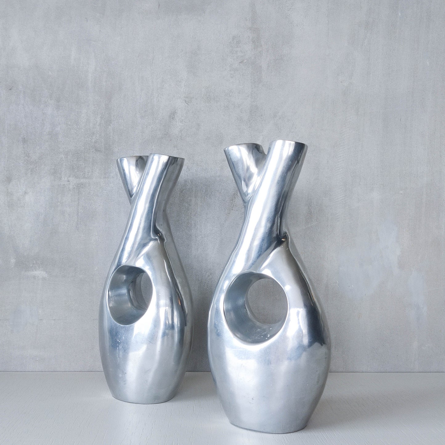 Pair of vintage cast aluminium sculptural donut twist vases