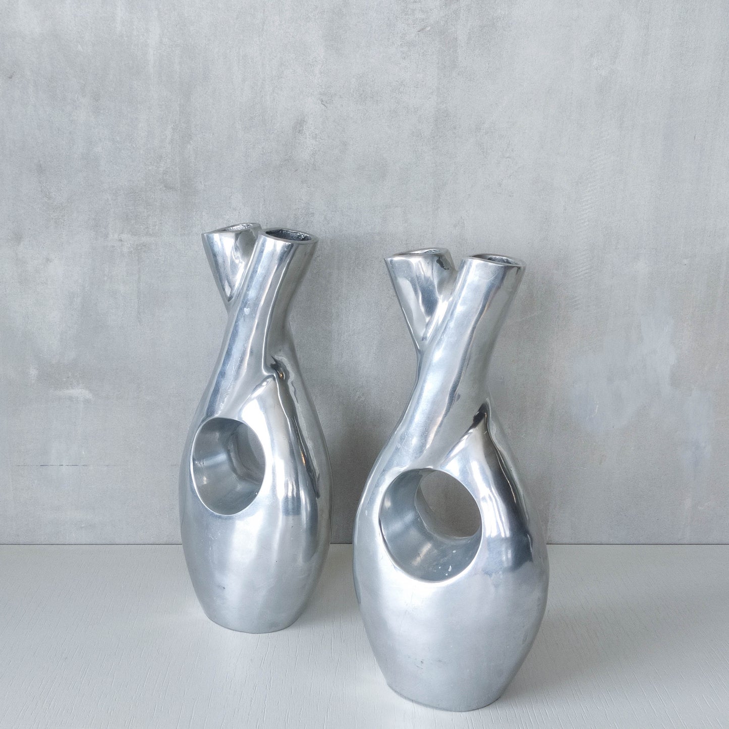 Pair of vintage cast aluminium sculptural donut twist vases