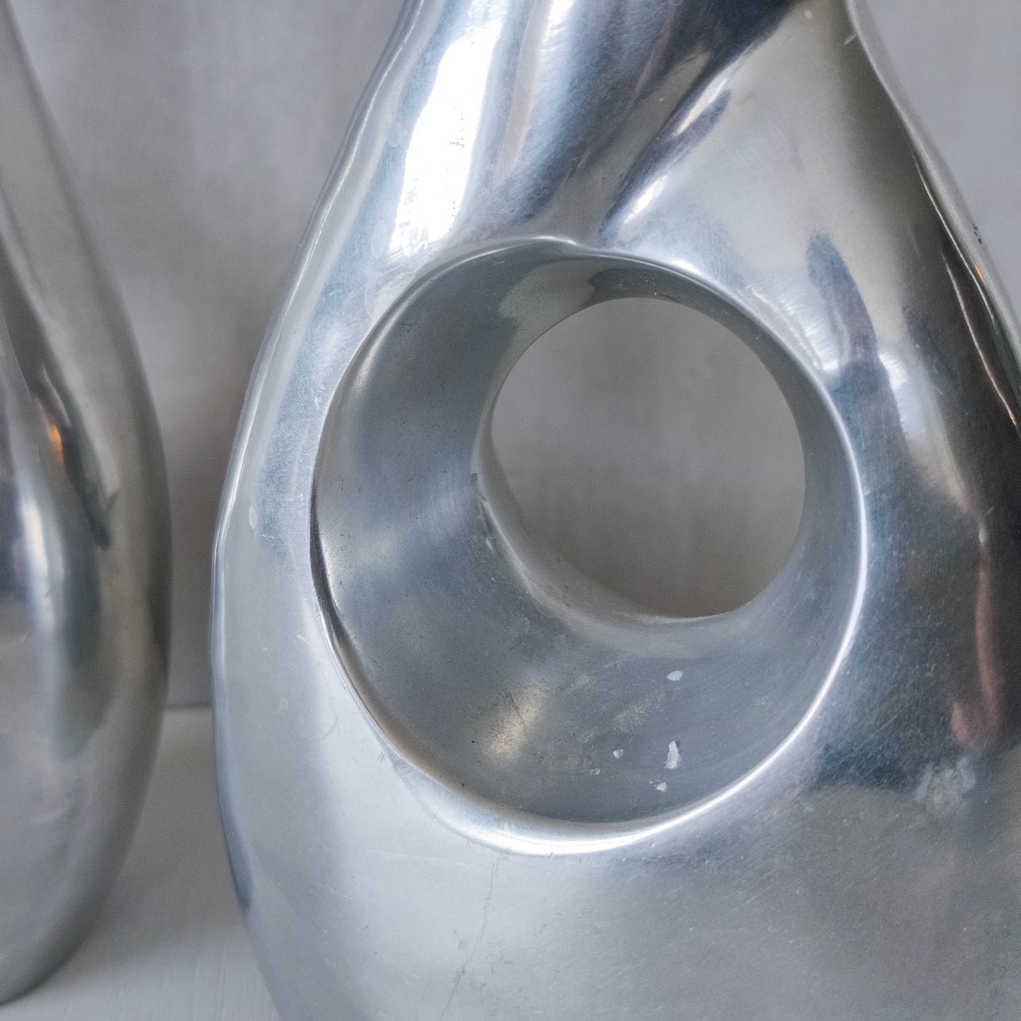 Pair of vintage cast aluminium sculptural donut twist vases