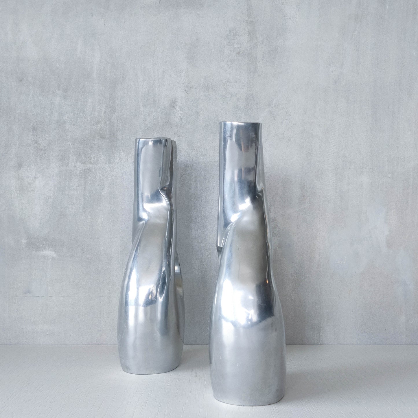 Pair of vintage cast aluminium sculptural donut twist vases