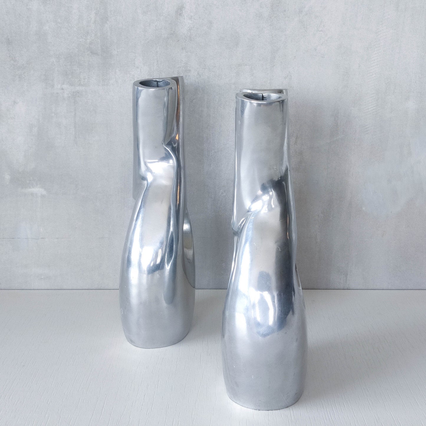Pair of vintage cast aluminium sculptural donut twist vases