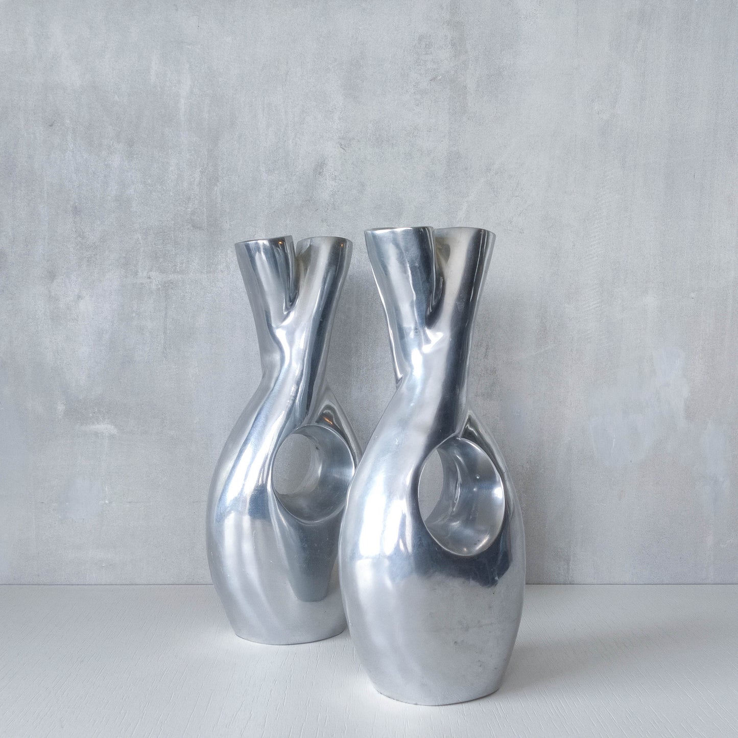 Pair of vintage cast aluminium sculptural donut twist vases
