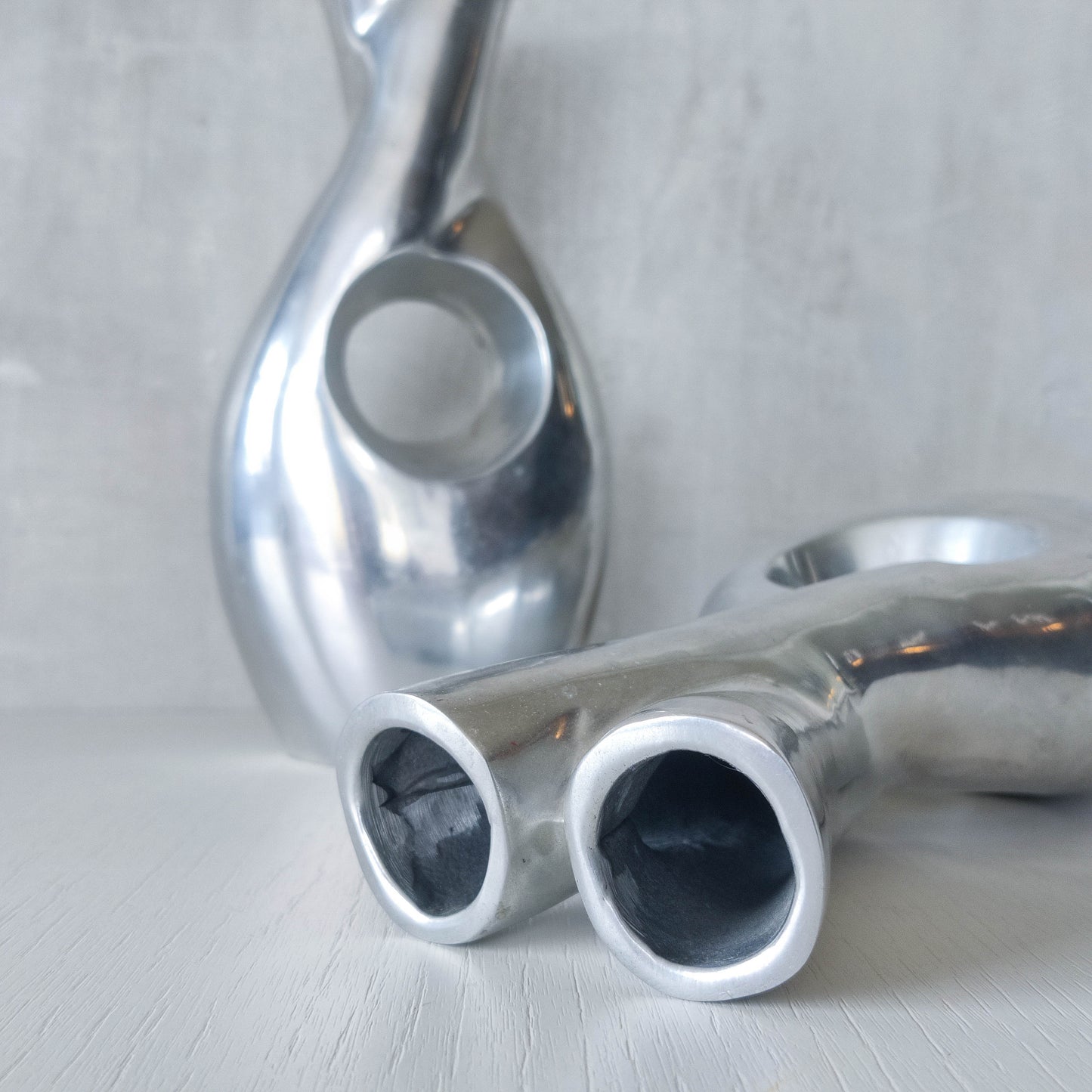 Pair of vintage cast aluminium sculptural donut twist vases