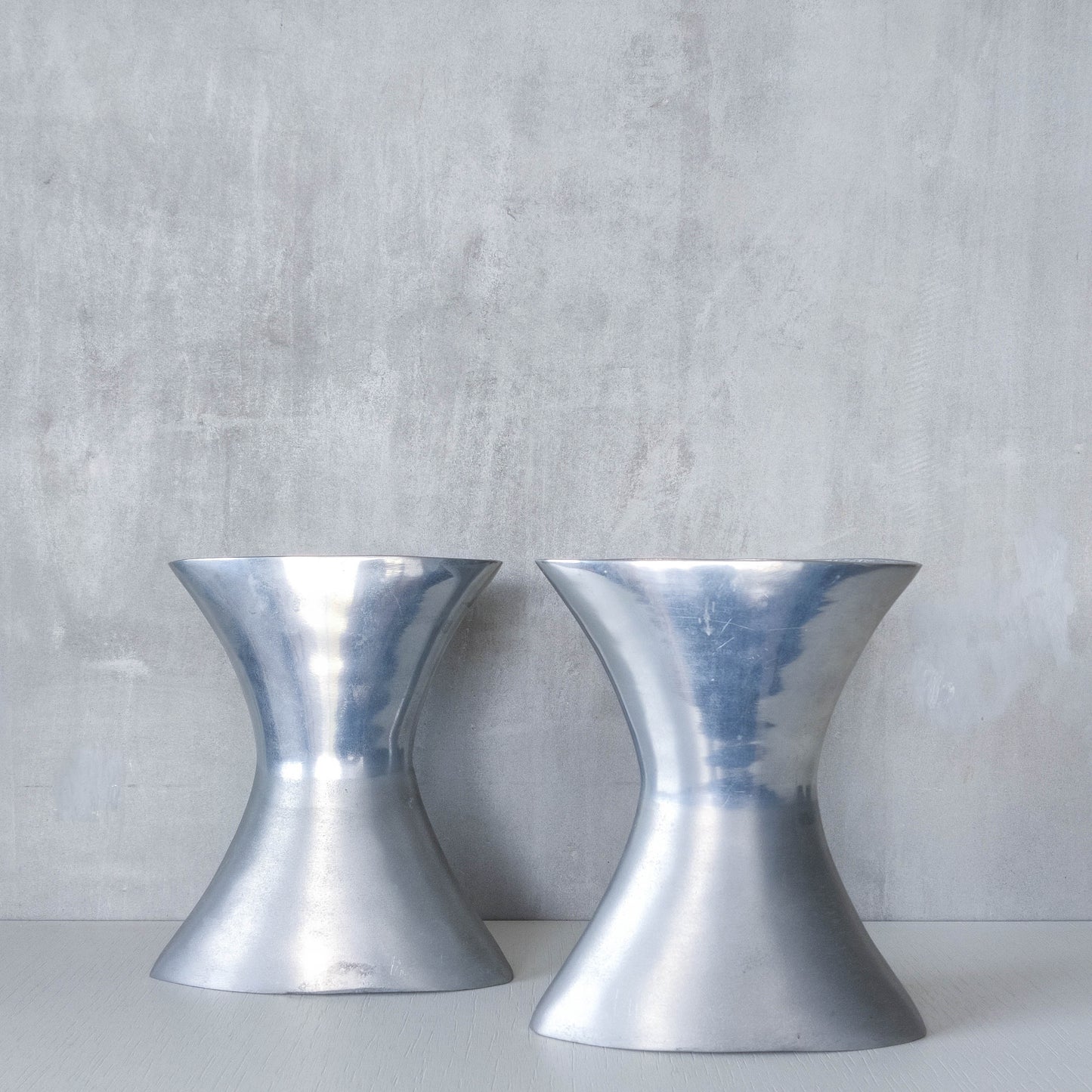 A pair of vintage sculptural cast aluminium flattened vases