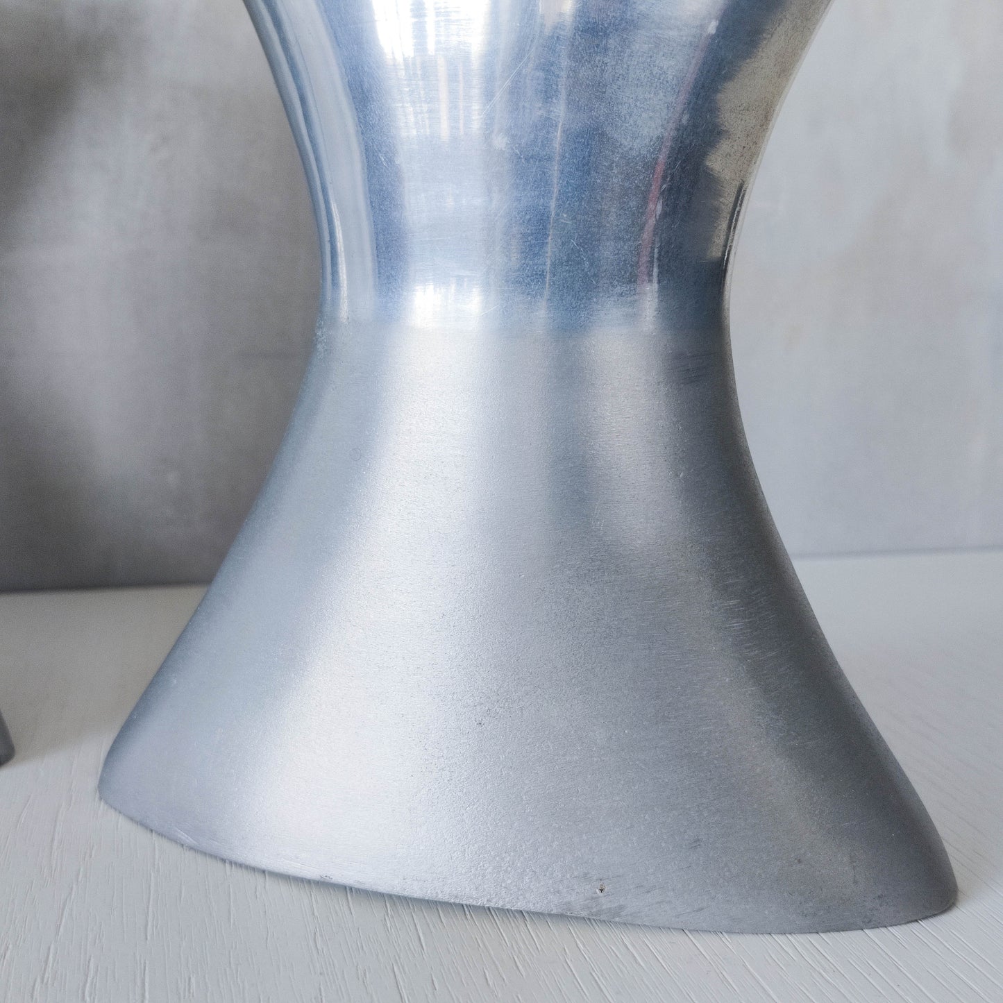 A pair of vintage sculptural cast aluminium flattened vases