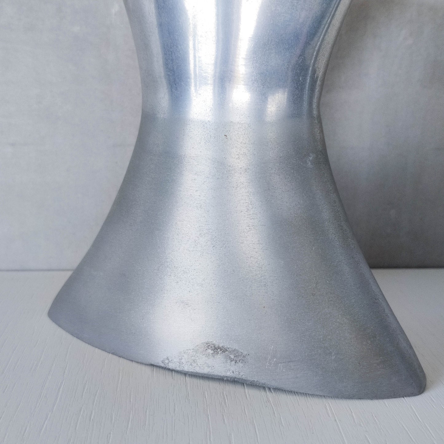 A pair of vintage sculptural cast aluminium flattened vases