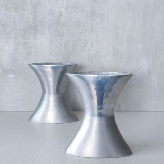 A pair of vintage sculptural cast aluminium flattened vases