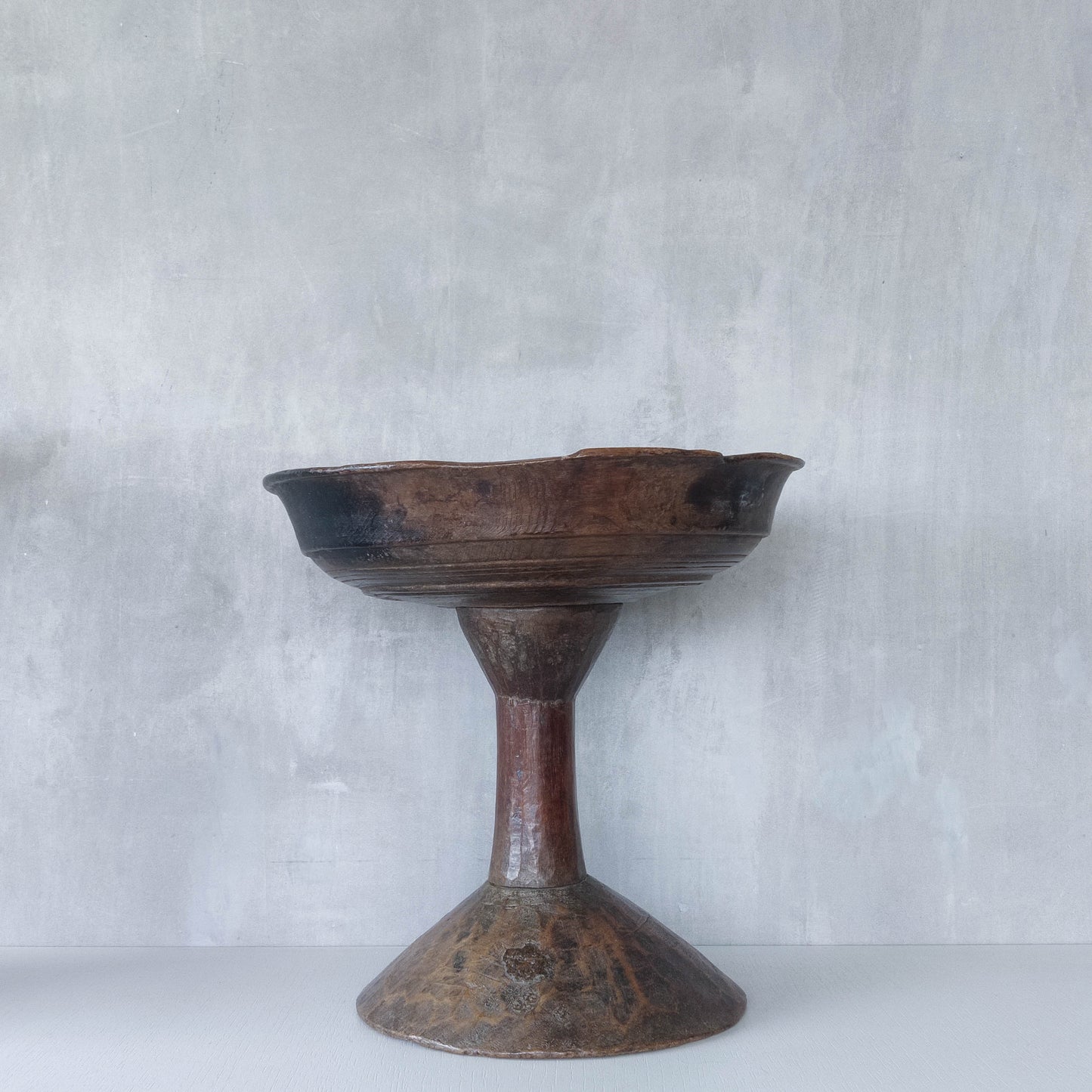 A large sculptural carved and turned vintage wooden pedestal bowl