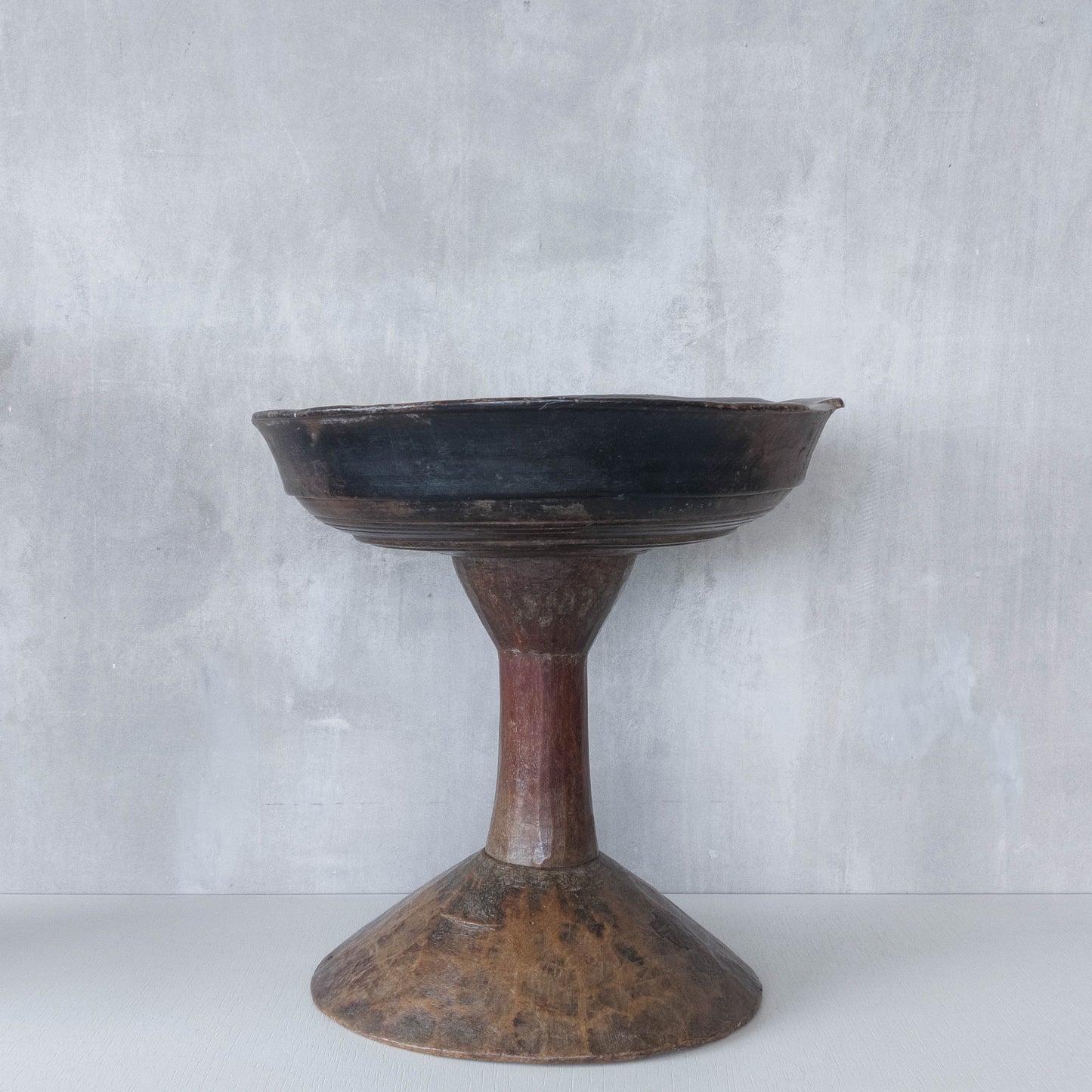 A large sculptural carved and turned vintage wooden pedestal bowl