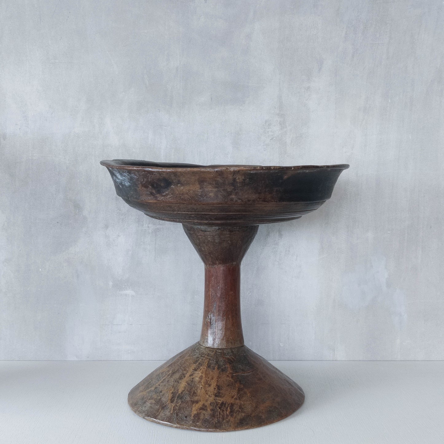 A large sculptural carved and turned vintage wooden pedestal bowl