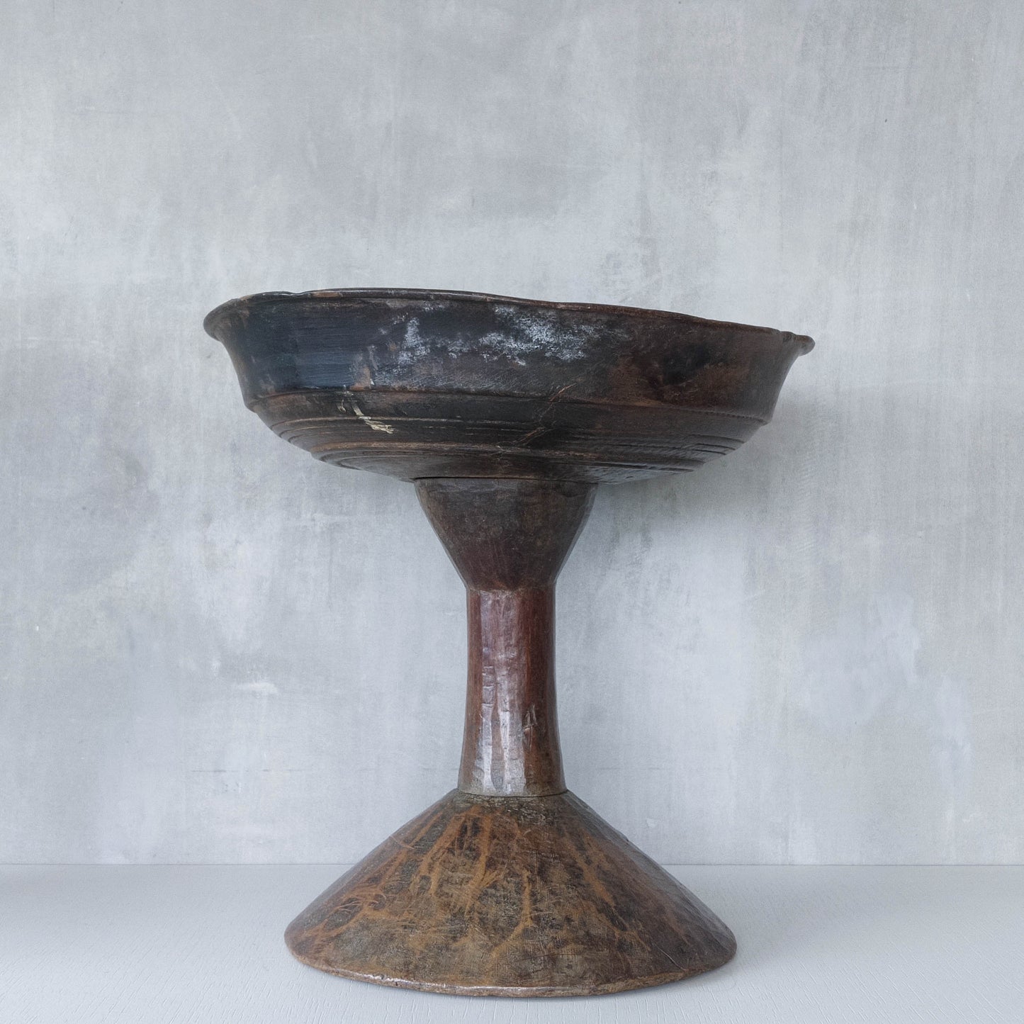A large sculptural carved and turned vintage wooden pedestal bowl