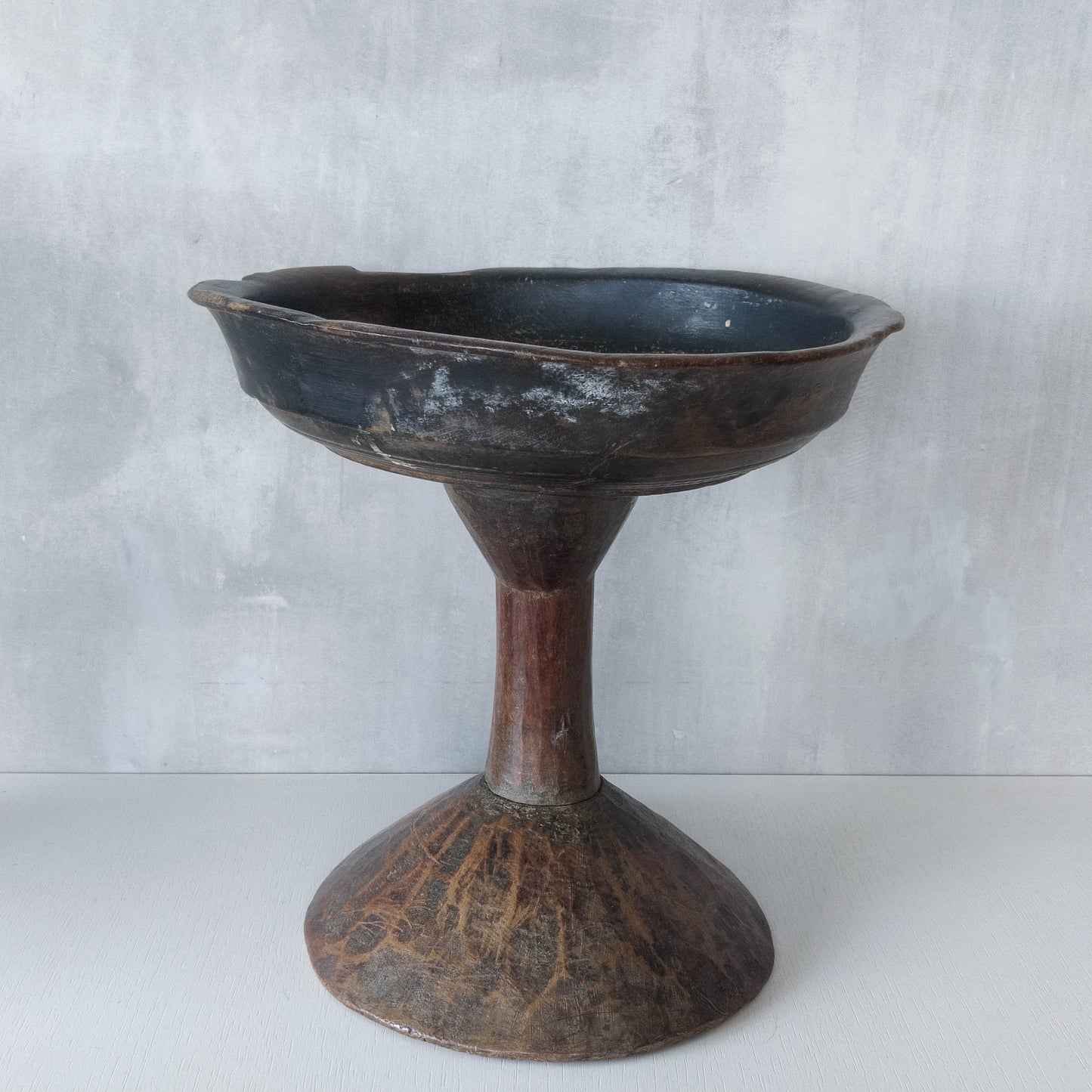 A large sculptural carved and turned vintage wooden pedestal bowl