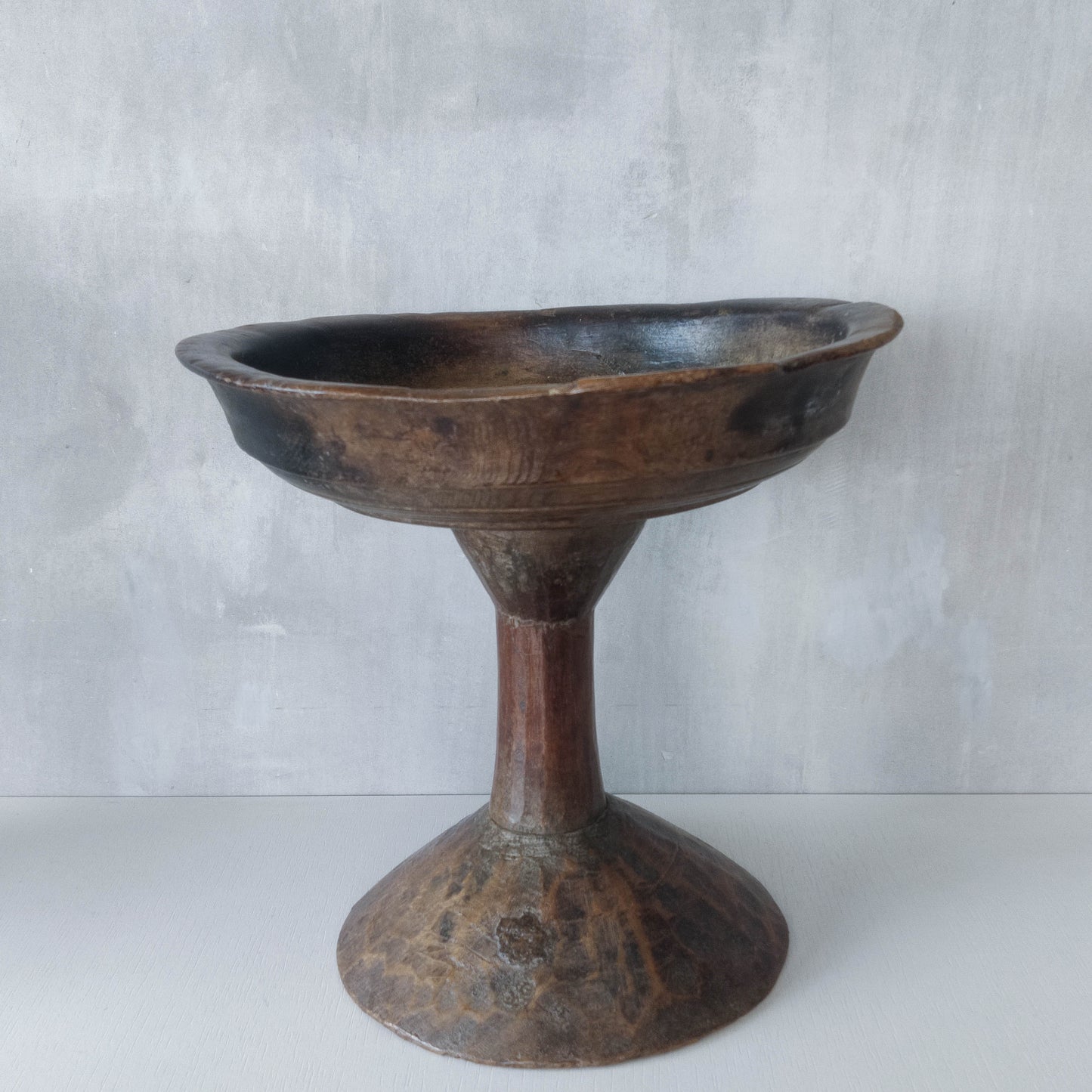 A large sculptural carved and turned vintage wooden pedestal bowl