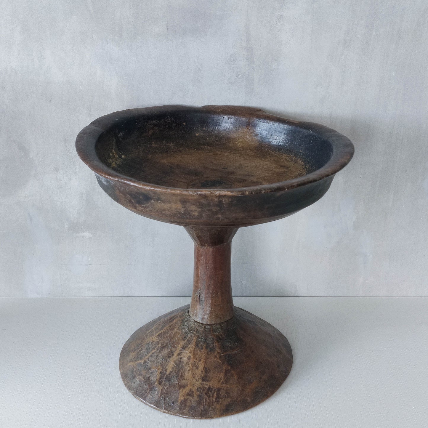 A large sculptural carved and turned vintage wooden pedestal bowl