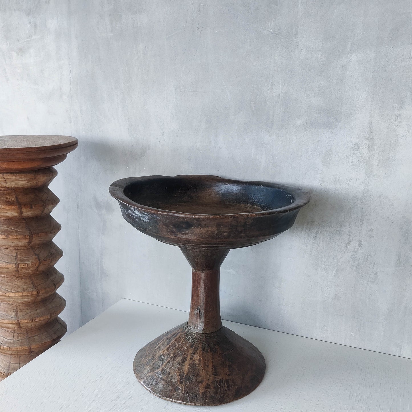 A large sculptural carved and turned vintage wooden pedestal bowl