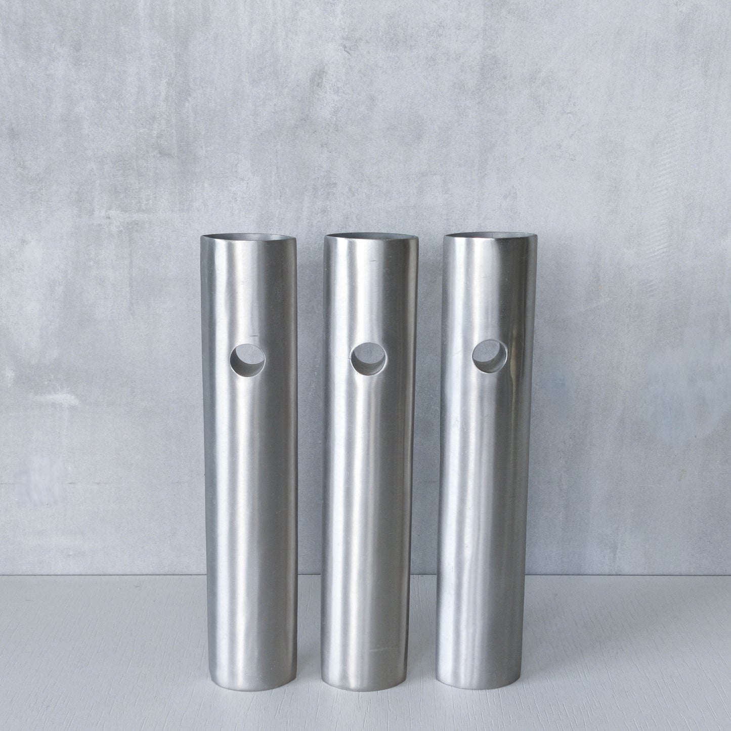 Trio of vintage artist made spun steel sculptural donut void bud vases