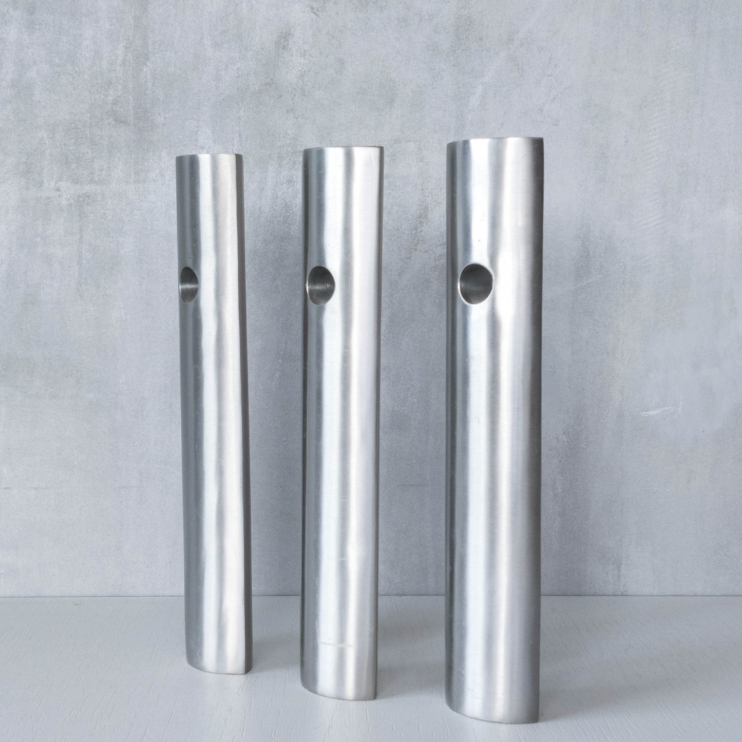 Trio of vintage artist made spun steel sculptural donut void bud vases