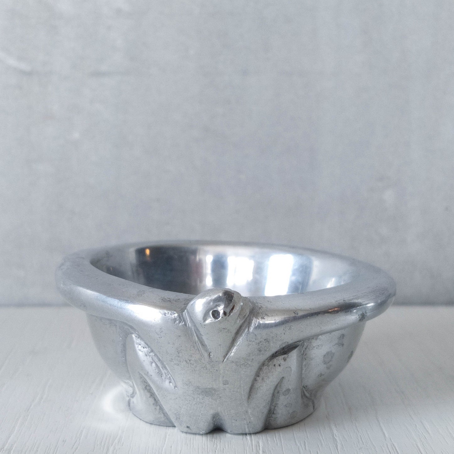 A pair of Carrol Boyes small figural cast aluminium bowls or tea light holders