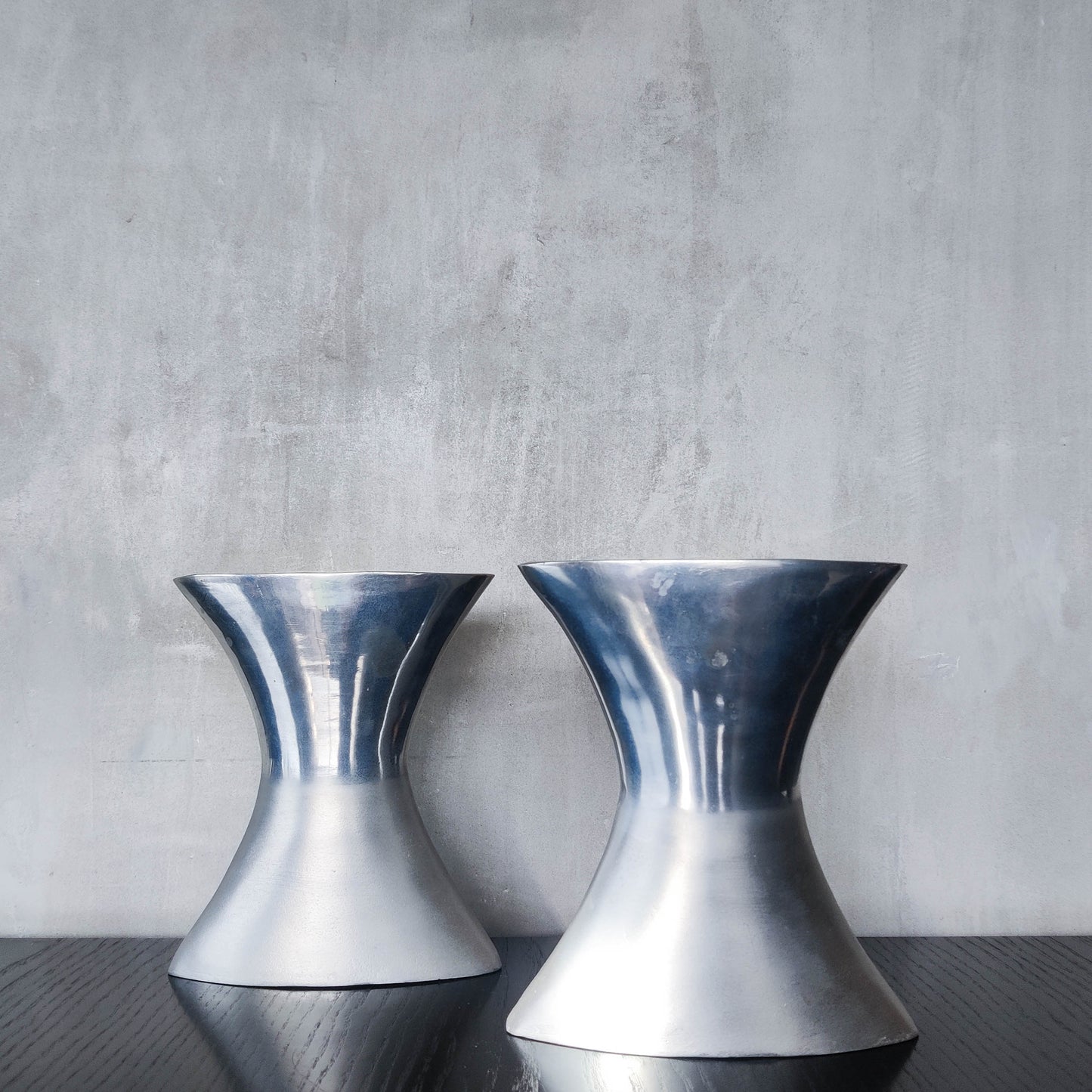 A pair of vintage sculptural cast aluminium flattened vases