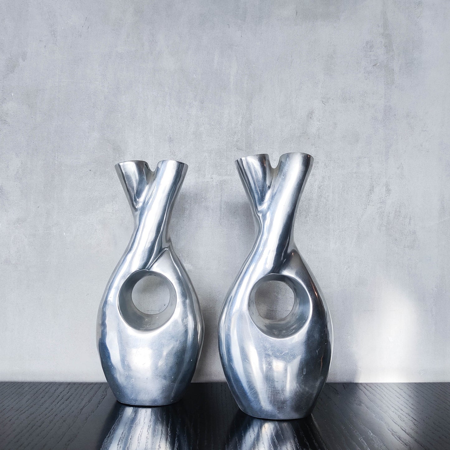 Pair of vintage cast aluminium sculptural donut twist vases
