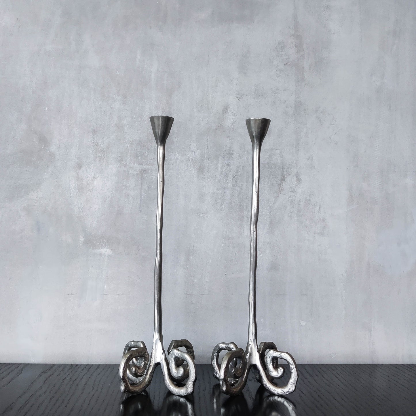 Pair of vintage cast aluminium candle holders with spiral feet